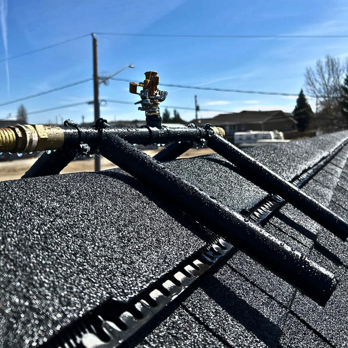 Rooftop-mounted sprinkler assembly used for exterior wildfire ember defense on residential roofs.